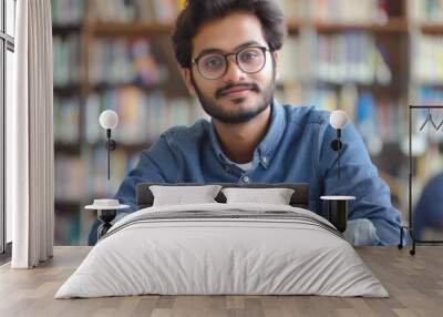 A person reading and learning from a book at a desk Wall mural