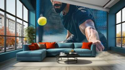 A person with a beard hits a tennis ball on a court, a sport and leisure activity Wall mural