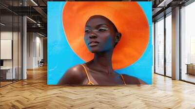 A woman wearing a bright orange hat, perfect for outdoor activities or fashion photography Wall mural