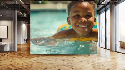 A young boy smiling as he floats on the surface of a pool Wall mural