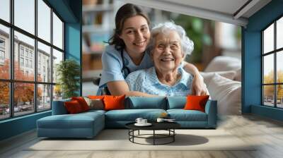 cheerful nurse hugging smiling senior woman Wall mural