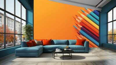 Colourful pencils composition on a orange background Wall mural