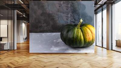 Green pumpkin on grey cement background. Autumn creative concept with copy space Wall mural