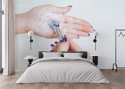 Hygienic care of makeup artist tools, women's hands wash the brush from cosmetics, soap and cleaning products, Wall mural