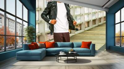 young man casual fashion in new york. young african american guy with beard, wearing black leather j Wall mural