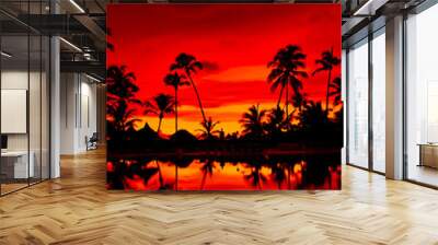 Orange and red sunset over sea beach with palms Wall mural