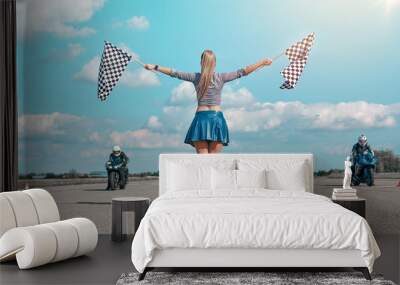 girl on a motorcycle race with starting flags Wall mural