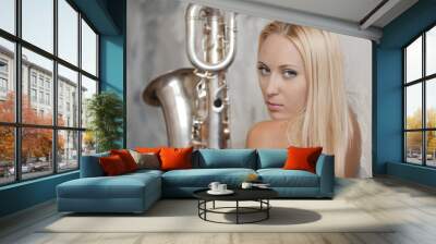 The beautiful girl has control over a saxophone Wall mural