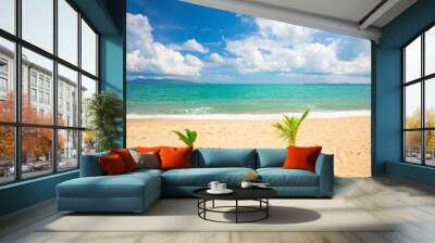 beautiful sandy beach and tropical sea with two little palm tree Wall mural