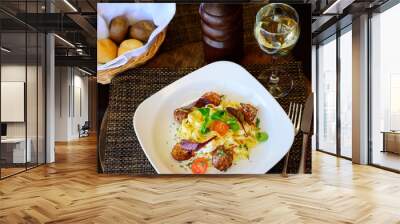 Pasta with meat, sauce and tomatoes on a plate Wall mural