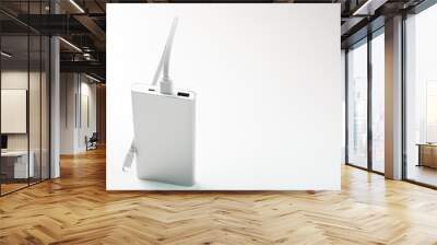 Powerbank for charging mobile devices with cable, on a white background. Wall mural