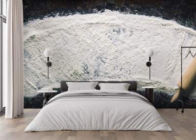 Abstract baking background with the rolling pin and flour on dark table Wall mural