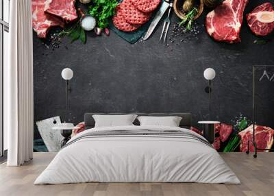 Assortment of raw cuts of meat, dry aged beef steaks and hamburger patties Wall mural