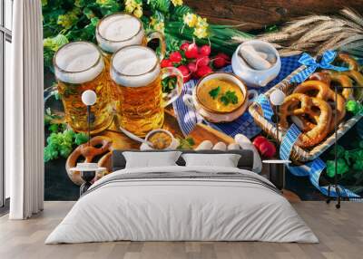 Bavarian sausages with pretzels, sweet mustard and beer mugs on rustic wooden table Wall mural