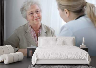 doctor explaining diagnosis to his female patient Wall mural