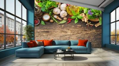 Fresh herbs and spices on wooden table Wall mural