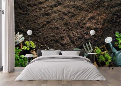 Gardening tools and seedlings on soil Wall mural