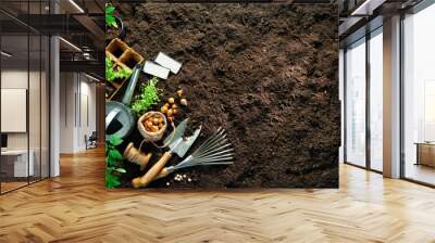 Gardening tools and seedlings on soil Wall mural