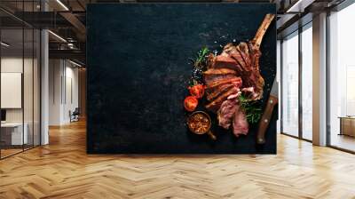 Grilled dry aged tomahawk steak sliced as close-up Wall mural