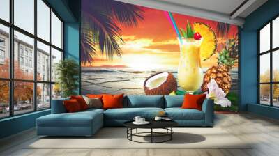 Pina colada fresh cocktail drink served on the beach at sunset Wall mural