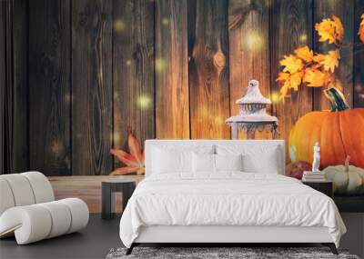 Pumpkins with fruits and falling leaves on rustic wooden table Wall mural