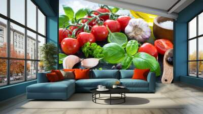 Ripe tomatoes with fresh basil, garlic and other herbs with water drops on slate plate Wall mural