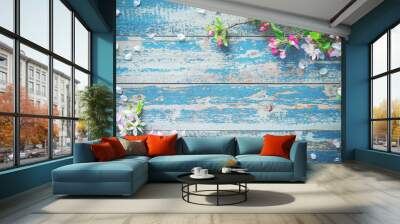 Spring blooming branches on blue wooden background. Wall mural