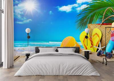 Tropical beach with sunbathing accessories, summer holiday background Wall mural