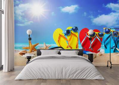 Tropical beach with sunbathing accessories, summer holiday background Wall mural