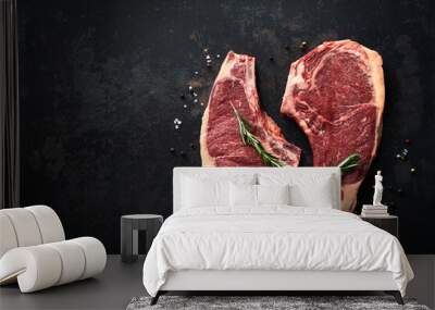 Two raw dry aged beef rib steaks (cote de boeuf)  with rosemary, pepper and salt Wall mural