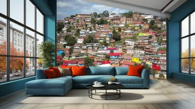 VENEZUELA,CARACAS,POVERTY,SLUM. Impressive view of a Caracas neighborhood called La San Agustín on a green hill in Caracas Venezuela. Wall mural