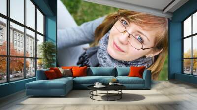 The person of the young girl in glasses Wall mural