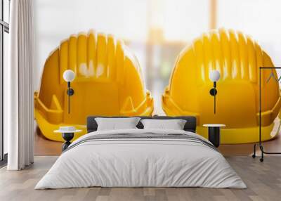 two yellow hard hats are on a table Wall mural