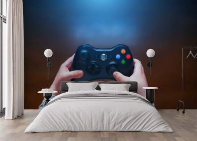 Video game controller in children's hands, in front of the TV Wall mural