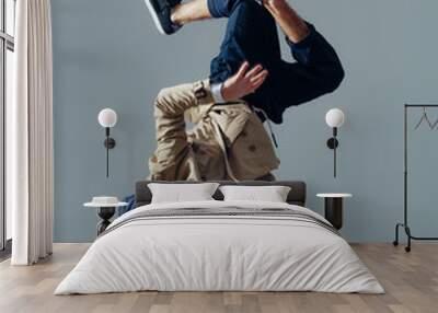 Young beautiful male dancer posing in studio Wall mural