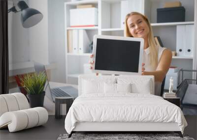 young beautiful woman work on tablet hold show screen sit at table in office smile Wall mural