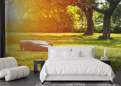 Automatic lawnmower in modern garden in sunny day Wall mural