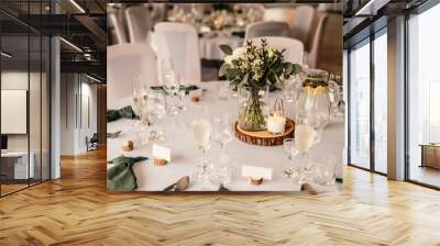 Decorated hall for wedding ceremony. Wedding. Banquet. The chairs and round table for guests, served with cutlery, flowers. Wall mural