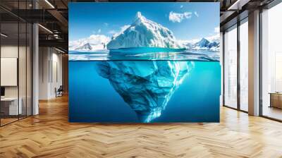 A breathtaking iceberg reflected in the still water under a clear blue sky highlighting its immense underwater portion Wall mural