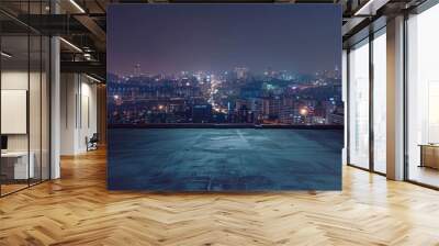 A city skyline at night with a dark sky and a few clouds Wall mural