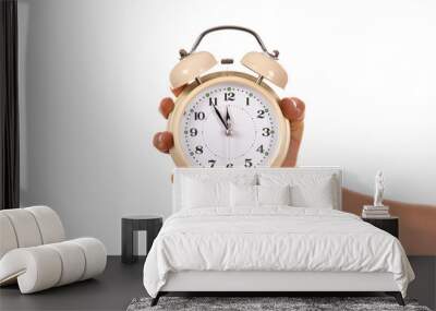 Alarm clock in hand on white background Wall mural