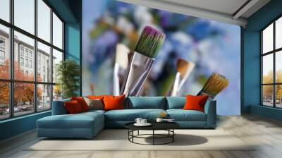 Artistic brushes on the background of a painting with a paint Wall mural