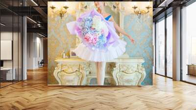 beautiful young woman in ballerina costume with a huge bouquet of blue flowers Wall mural