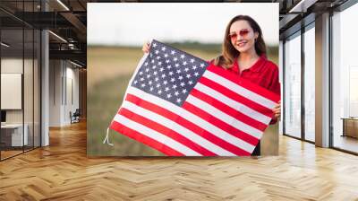 beautiful young woman in pink sunglasses with american flag Wall mural