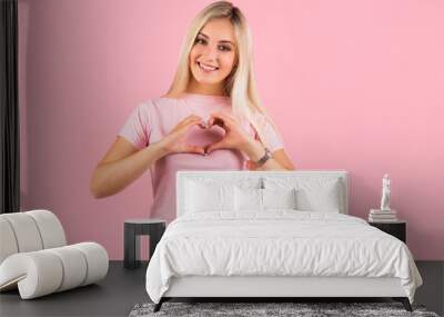 beautiful young woman on pink background with hand gesture Wall mural