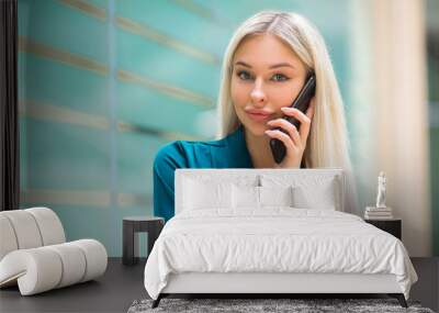 beautiful young woman with flowing white hair talking on the phone at work in the office Wall mural