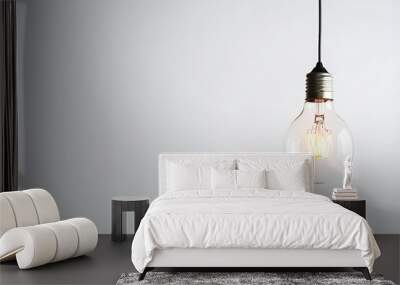 Illuminated light bulb on white background Wall mural