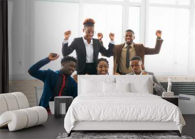 team of young african people in the office at the table with a laptop  Wall mural