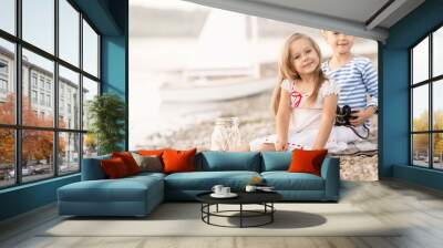 Boy with a girl sitting on the beach Wall mural