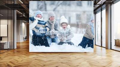 Children playing in the snow on a winter day Wall mural